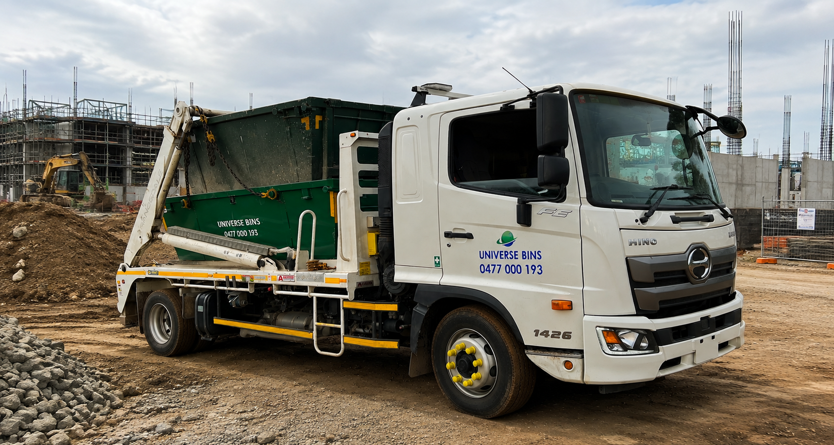 A Universe Bins truck with a skip bin on a Melbourne building site beside piles of soil and gravel